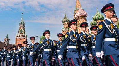 Young men in military uniforms on Red Square in Moscow against the background of the Kremlin.