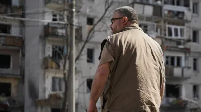 Man in Ukraine look at his destroyed home