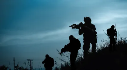 Silhouette of military soldier or officer with weapons at night.