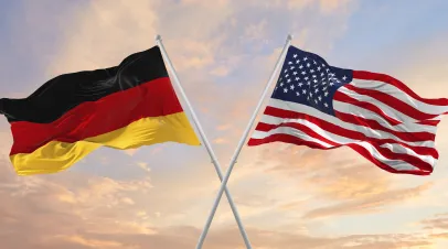 Flags of Germany and the United States waving beside one another