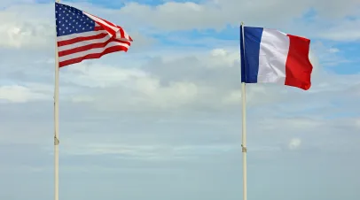 Flags of France and the US flying on poles next to one another