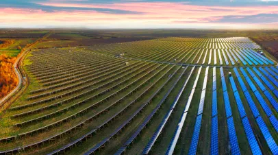 Field of solar panels in Ukraine under a sunset sky