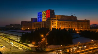 Romanian Parliament building with lights of the flag colors projected onto it