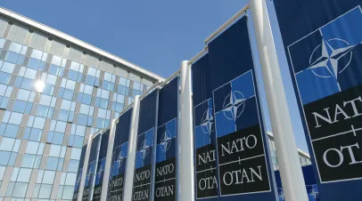 NATO logo flags in front of the headquarters building in Brussels, Belgium, 2022.