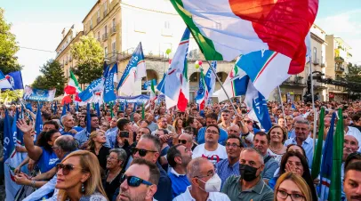 Crowd of people with Italian flags and political party flags in Italy