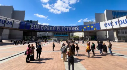 People walking towards a big banner reading European Elections