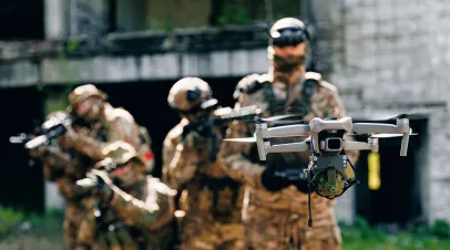 Solider controlling a hovering drone