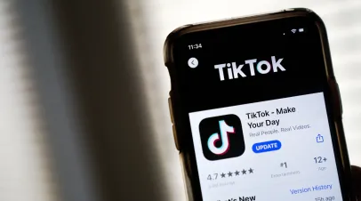 Phone with the app store listing for tiktok open