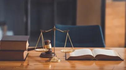 Table with scale, judge's gavel and law books