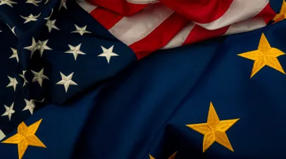 US flags and EU flags lying on top of one another