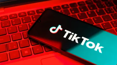 Prague, Czechia - 7 20 2024: Smartphone on surface showing TikTok logo.