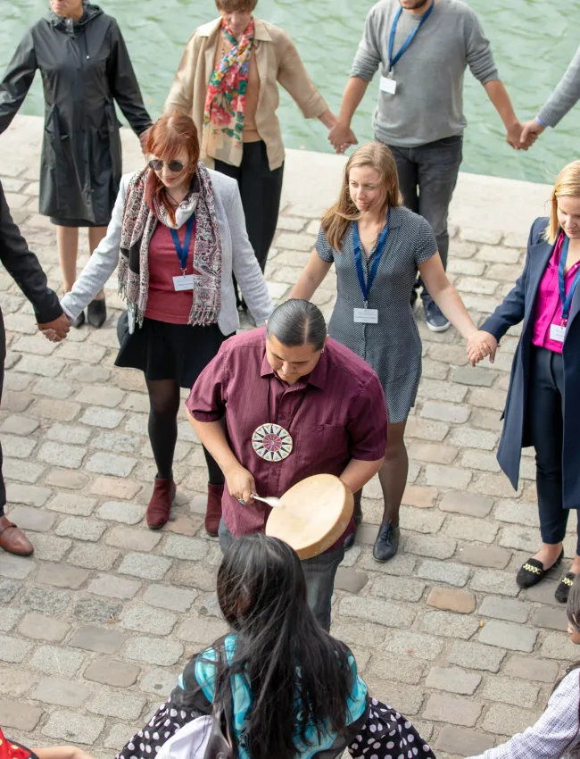 people in a circle holding hands